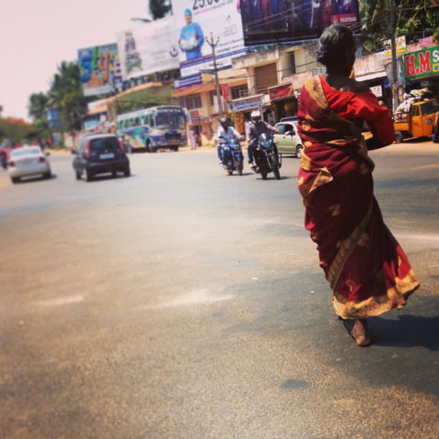 She's beautiful, unphased...barefoot and striding gracefully across the sizzling hot asphalt.